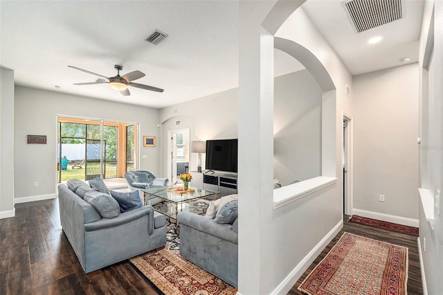 living room with ceiling fan and dark hardwood / wood-style floors