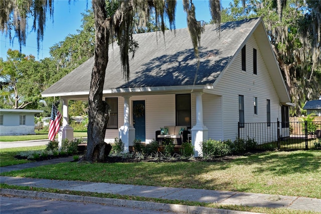 view of front of home with a porch and a front lawn