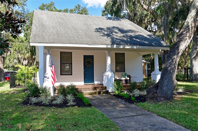 bungalow featuring a front yard and a porch