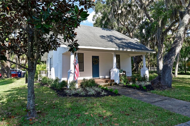 bungalow-style home with covered porch and a front lawn