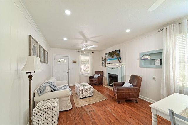 living room featuring ornamental molding, hardwood / wood-style floors, and ceiling fan