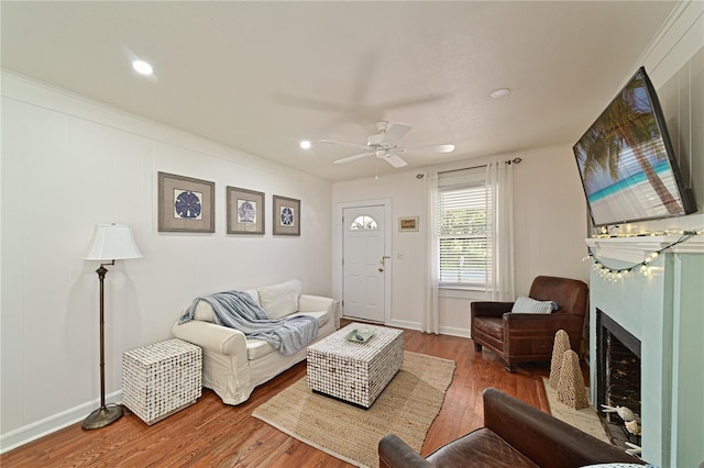 living room with hardwood / wood-style flooring and ceiling fan