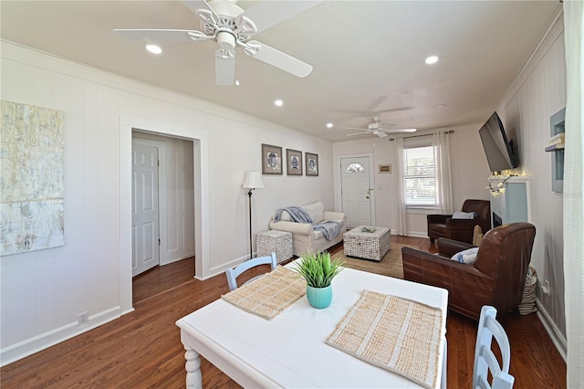 living room featuring crown molding, dark wood-type flooring, and ceiling fan