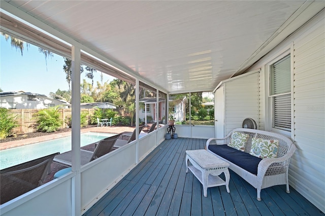 wooden terrace with a fenced in pool