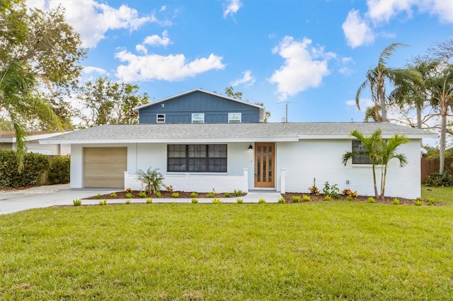 view of front of home with a front yard and a garage