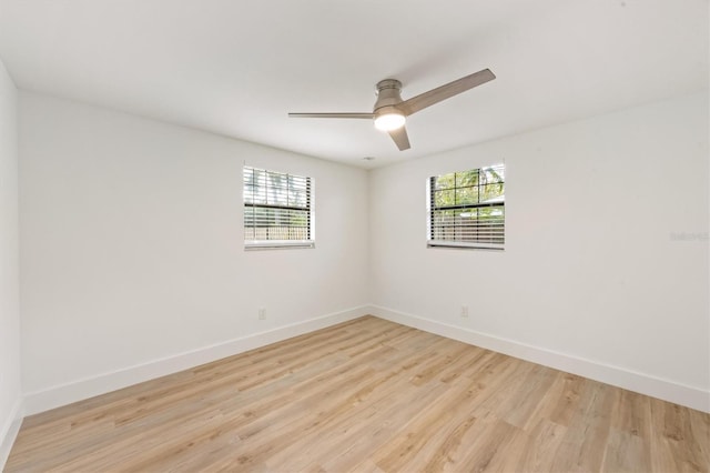 empty room with light wood-type flooring, a healthy amount of sunlight, and ceiling fan