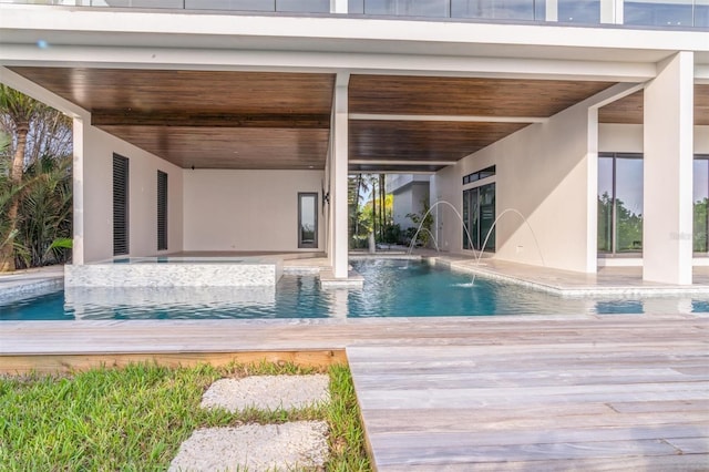 view of pool featuring pool water feature and a patio area