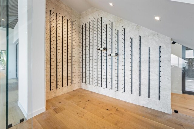 interior space with hardwood / wood-style flooring and vaulted ceiling