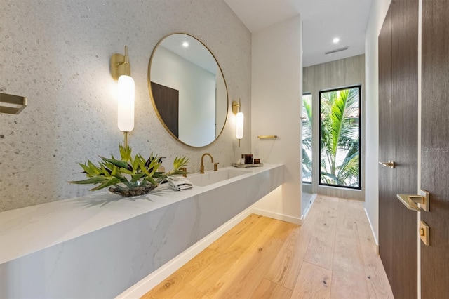 bathroom with vanity and hardwood / wood-style flooring