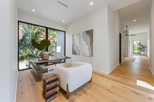 sitting room featuring light hardwood / wood-style floors and ceiling fan