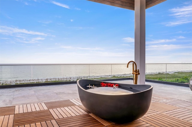 view of patio with a water view