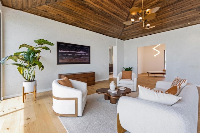 living room with wooden ceiling, light hardwood / wood-style floors, a chandelier, and high vaulted ceiling