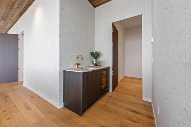 hallway featuring wood ceiling, sink, and light hardwood / wood-style flooring