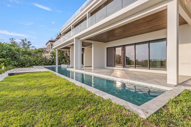 view of pool with a yard and a patio