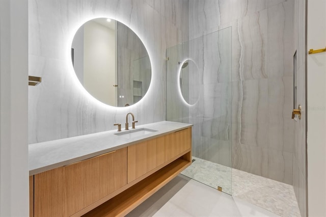 bathroom featuring vanity, tile patterned floors, and tile walls