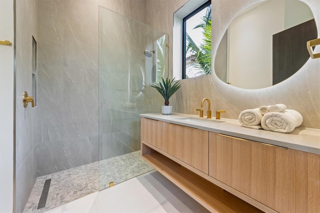 bathroom with vanity, decorative backsplash, and a tile shower