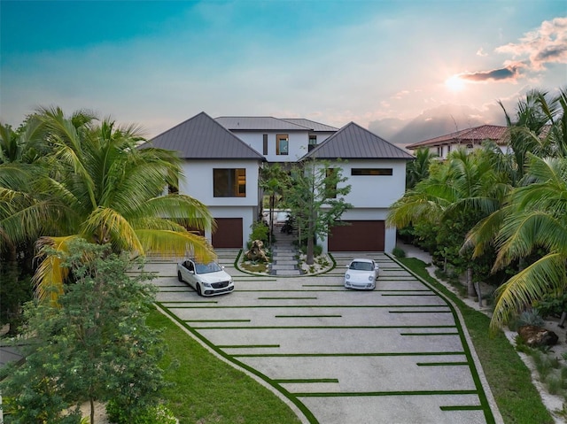 view of front of home featuring a lawn and a garage