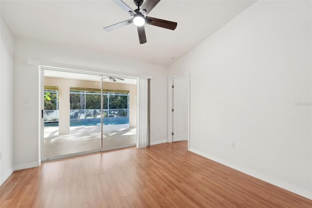 empty room with ceiling fan, light hardwood / wood-style flooring, and vaulted ceiling