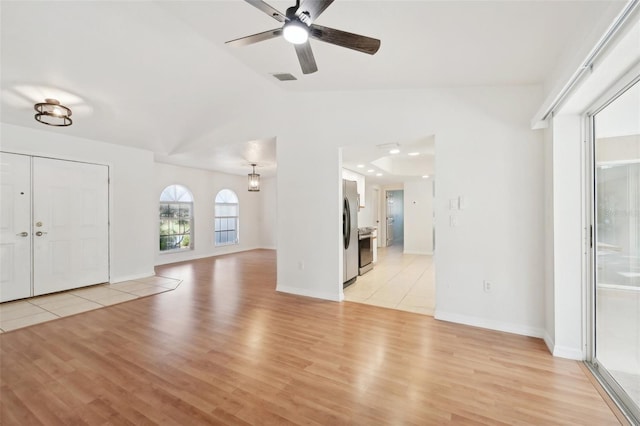 foyer featuring light wood-type flooring, lofted ceiling, and ceiling fan