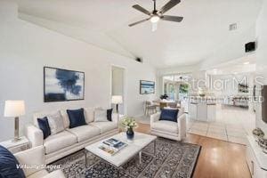 living room with hardwood / wood-style floors, vaulted ceiling, and ceiling fan