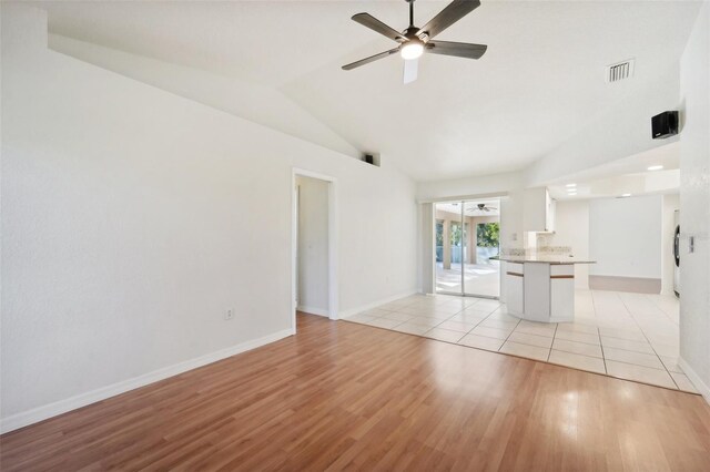 unfurnished living room with light wood-type flooring, lofted ceiling, and ceiling fan