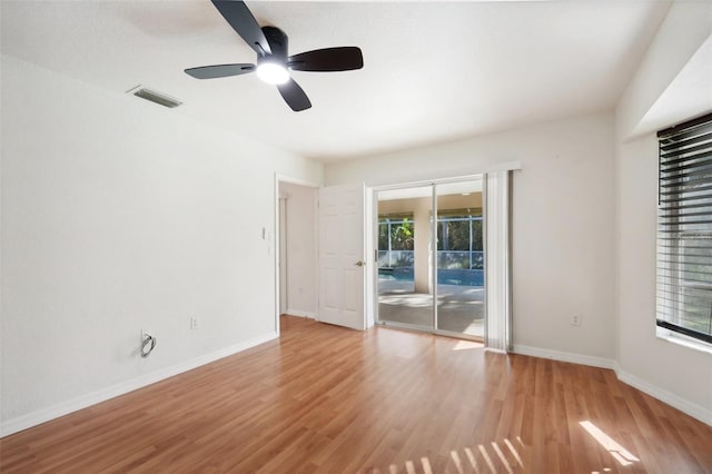 unfurnished room with ceiling fan, plenty of natural light, and light hardwood / wood-style flooring