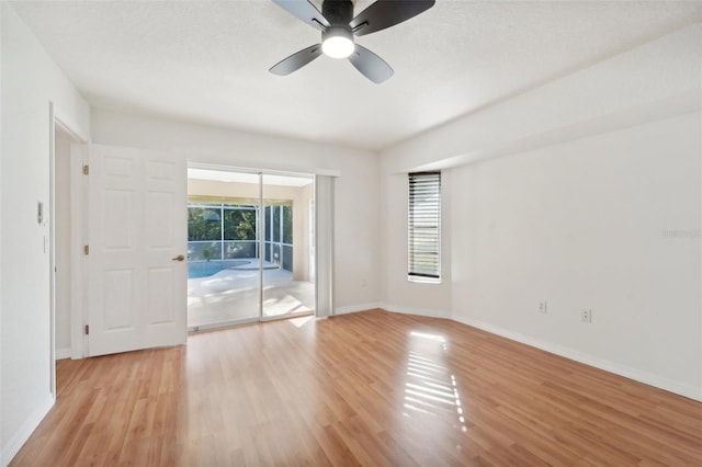 unfurnished room with ceiling fan, a textured ceiling, and light wood-type flooring