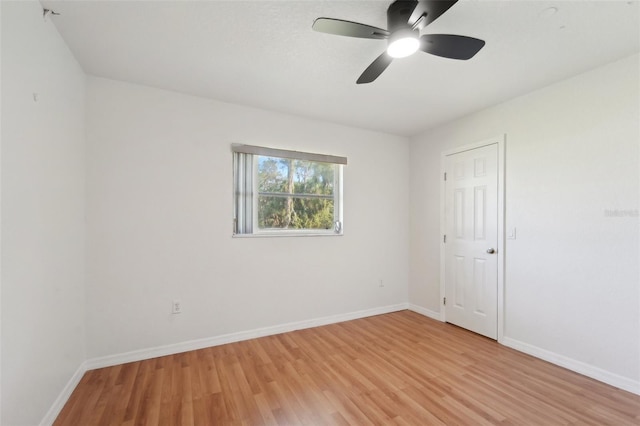 empty room featuring light wood-type flooring and ceiling fan