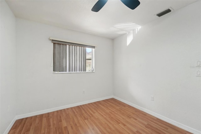 empty room featuring hardwood / wood-style flooring and ceiling fan