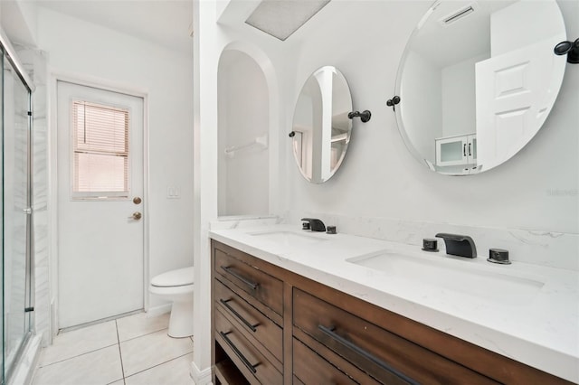 bathroom with toilet, an enclosed shower, vanity, and tile patterned floors