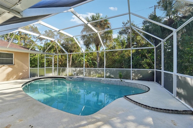 view of swimming pool with a patio area and a lanai