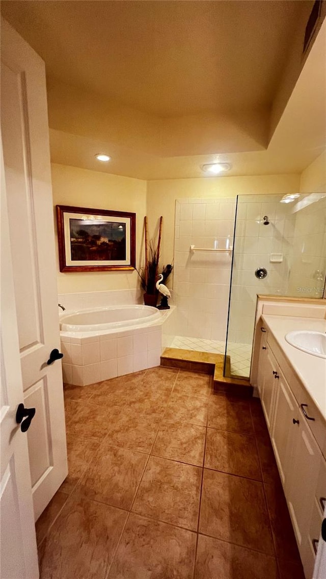 bathroom with vanity, tile patterned floors, and plus walk in shower