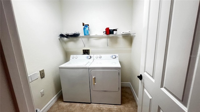 clothes washing area with washing machine and dryer