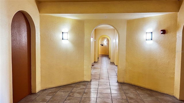 hallway with tile patterned flooring