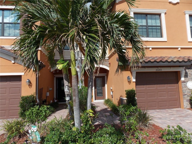 view of front of house featuring a garage and central AC