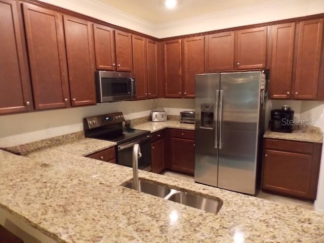 kitchen featuring light stone countertops, sink, ornamental molding, and appliances with stainless steel finishes