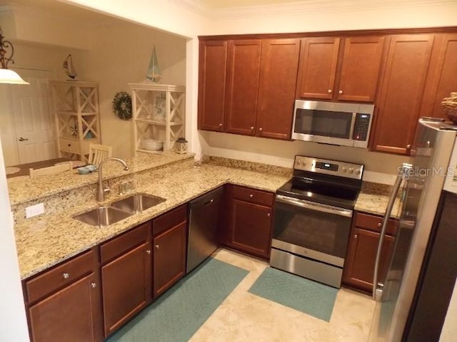 kitchen featuring sink, ornamental molding, appliances with stainless steel finishes, light stone counters, and kitchen peninsula