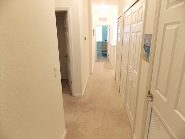 hall featuring light colored carpet