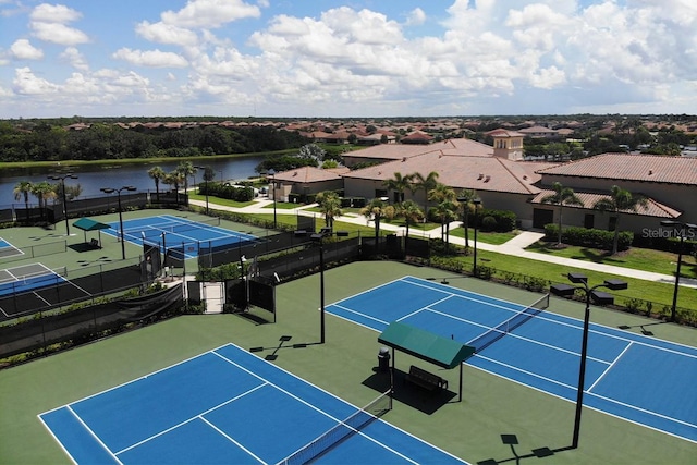 view of tennis court featuring a water view