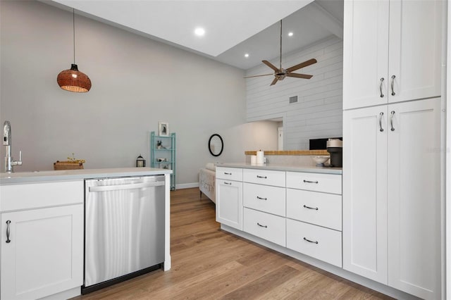 kitchen featuring dishwasher, high vaulted ceiling, white cabinetry, light wood-type flooring, and decorative light fixtures