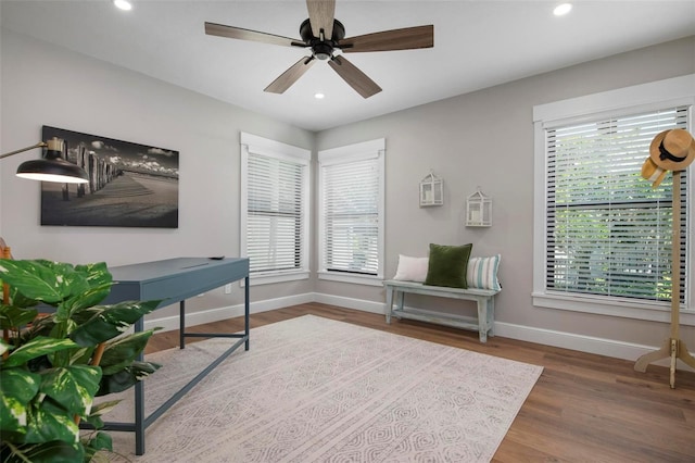 home office featuring dark wood-type flooring and ceiling fan