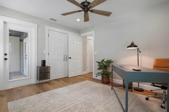 office area with light hardwood / wood-style floors and ceiling fan