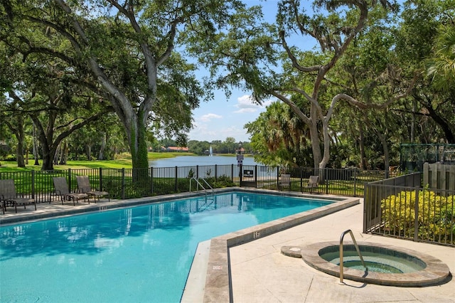 community pool with a community hot tub, a water view, and fence