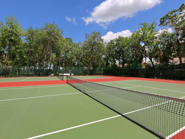 view of tennis court featuring fence