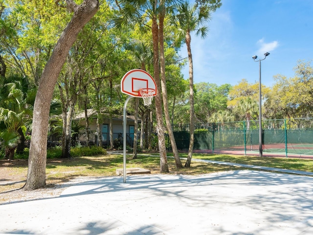 view of basketball court featuring community basketball court and fence