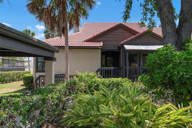 view of front of house featuring a tile roof and stucco siding