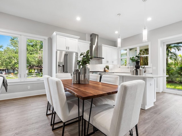 dining room with light hardwood / wood-style floors and sink