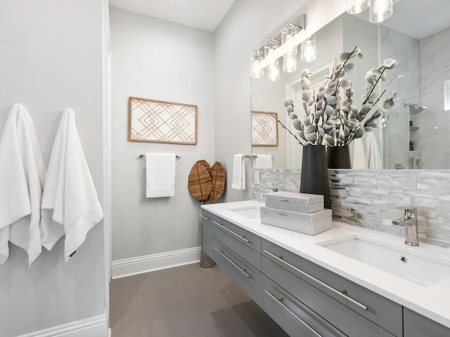 bathroom featuring vanity, decorative backsplash, and tiled shower