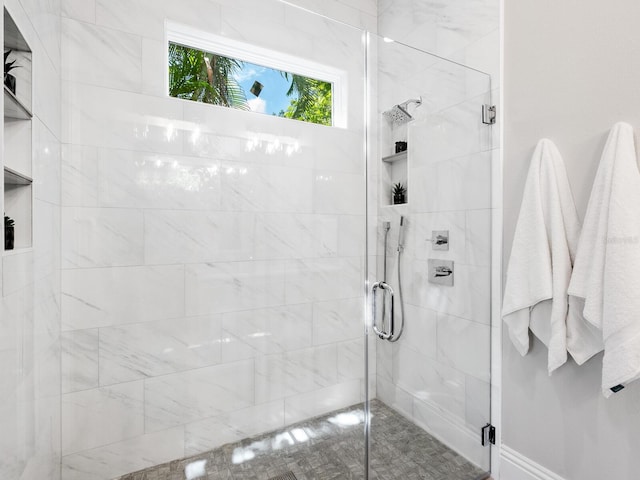 bathroom with a shower with shower door