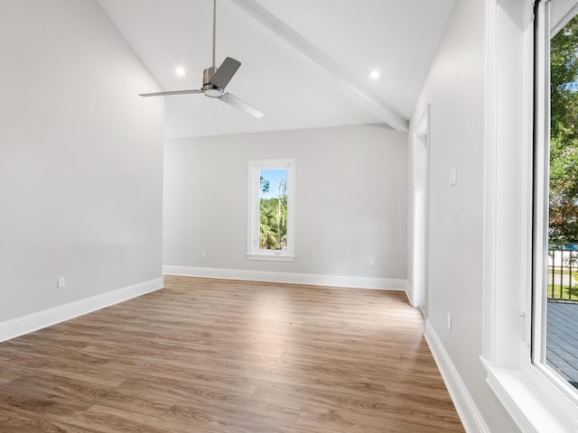 unfurnished room with lofted ceiling with beams, hardwood / wood-style flooring, and ceiling fan